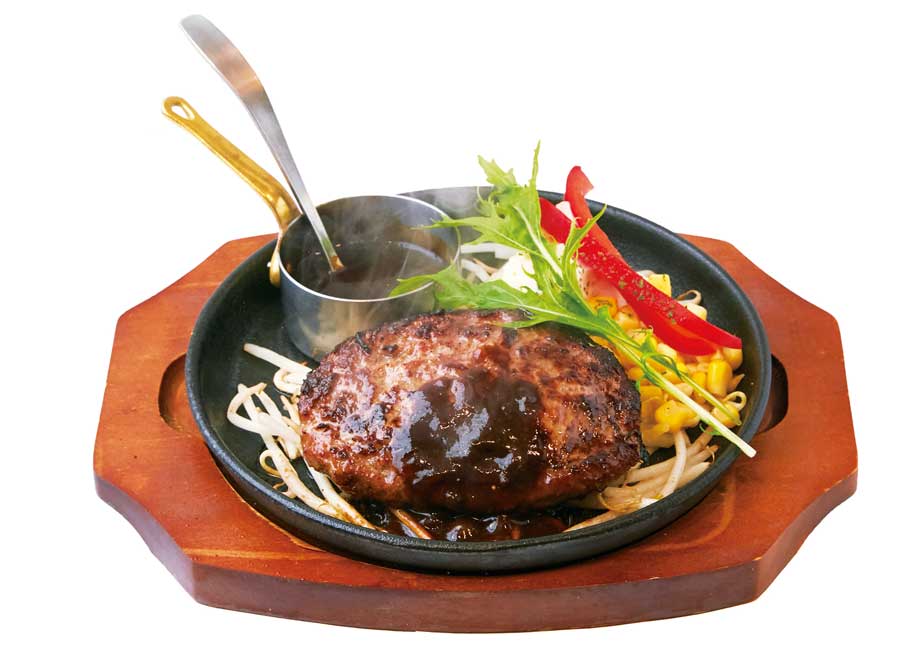 湯気が立ち上る鉄板のハンバーグ